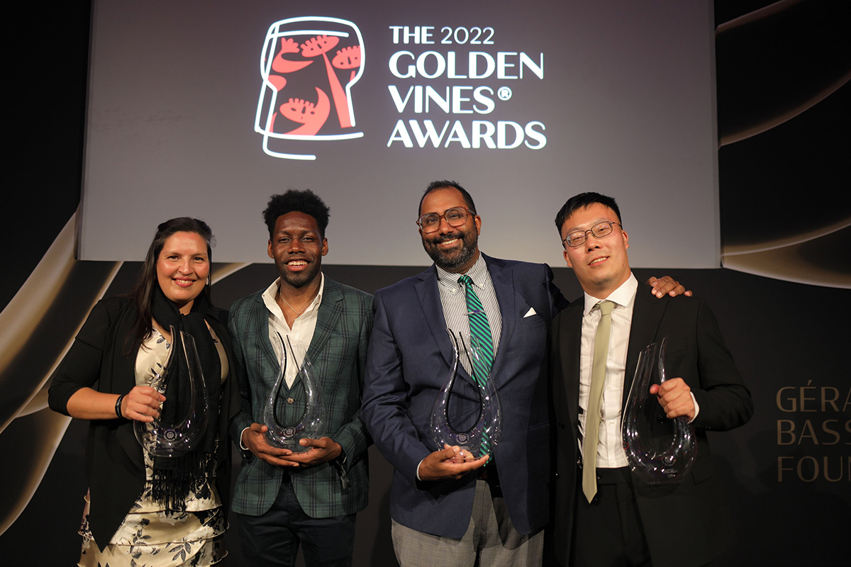 four men and a woman holding awards