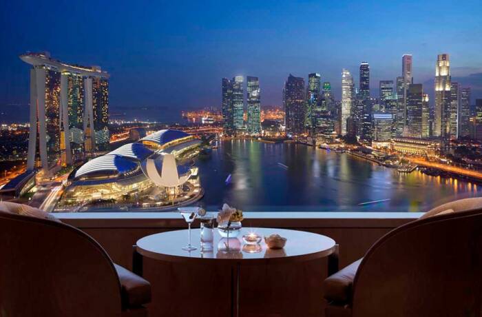 Hotel balcony overlooking Marina Bay at night