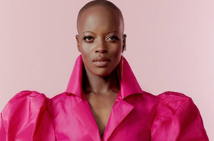 A woman wearing a pink shirt with puffy sleeves