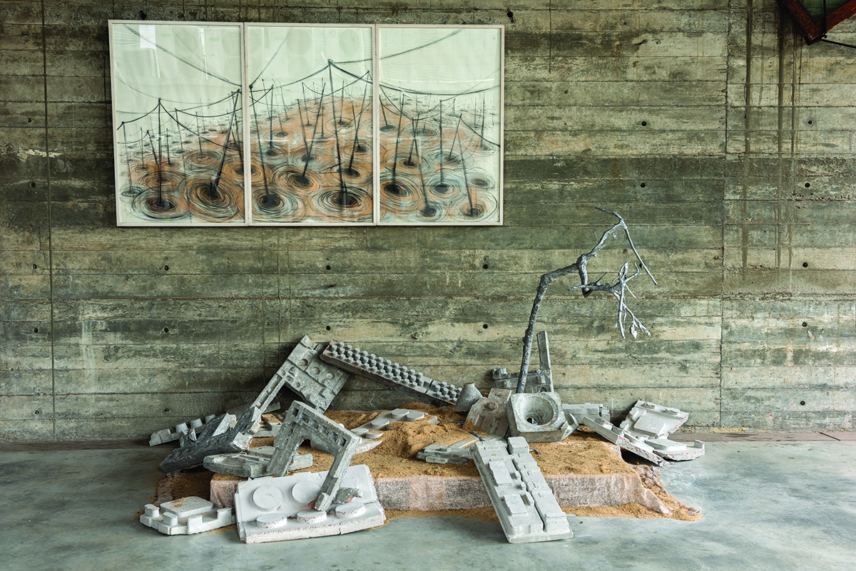 rubble and sand on the floor below a painting of power lines