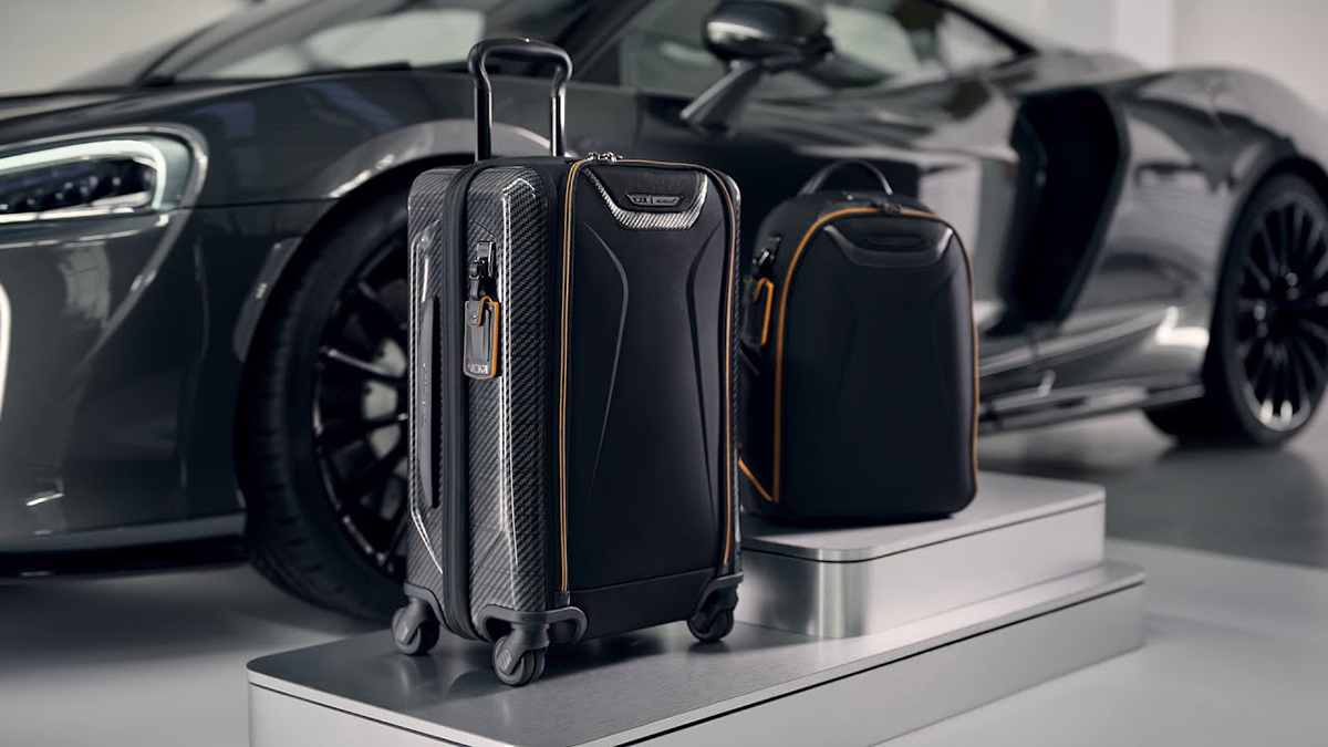 Black suitcase and luggage next to a car