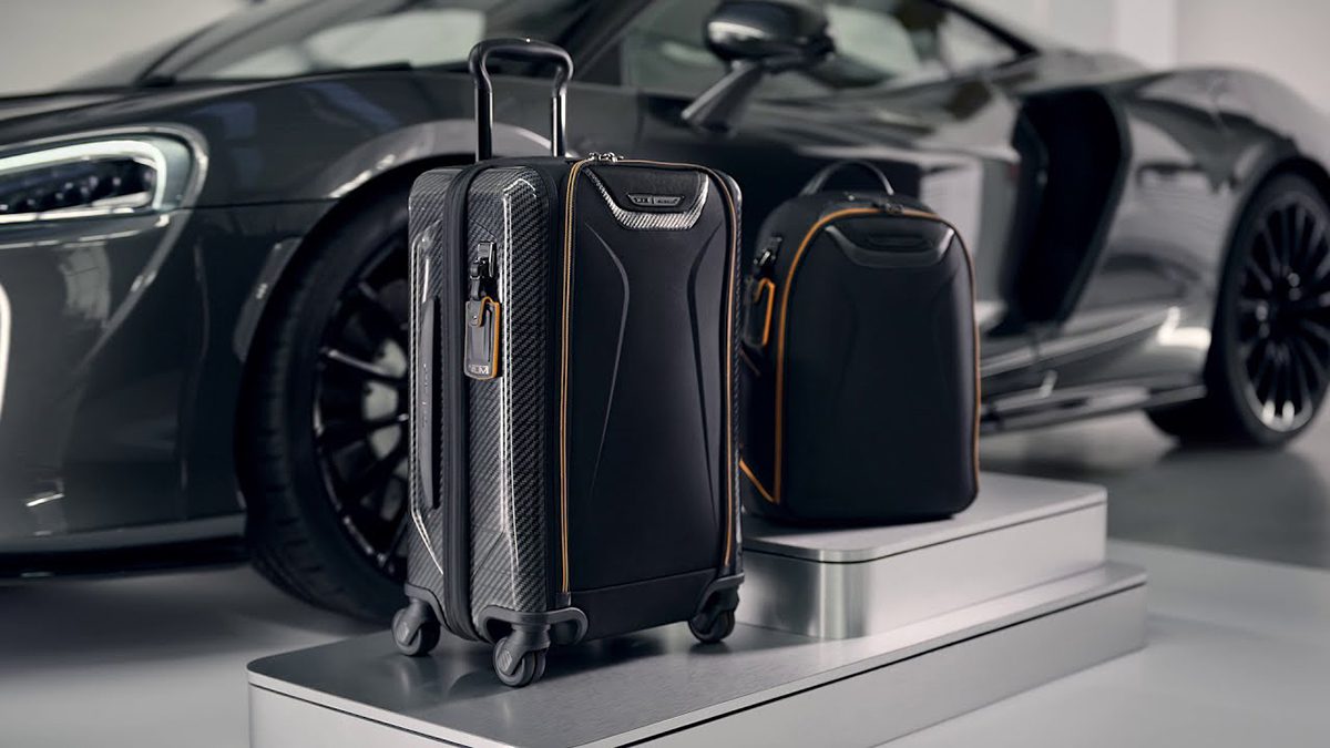 Black suitcase and luggage next to a car