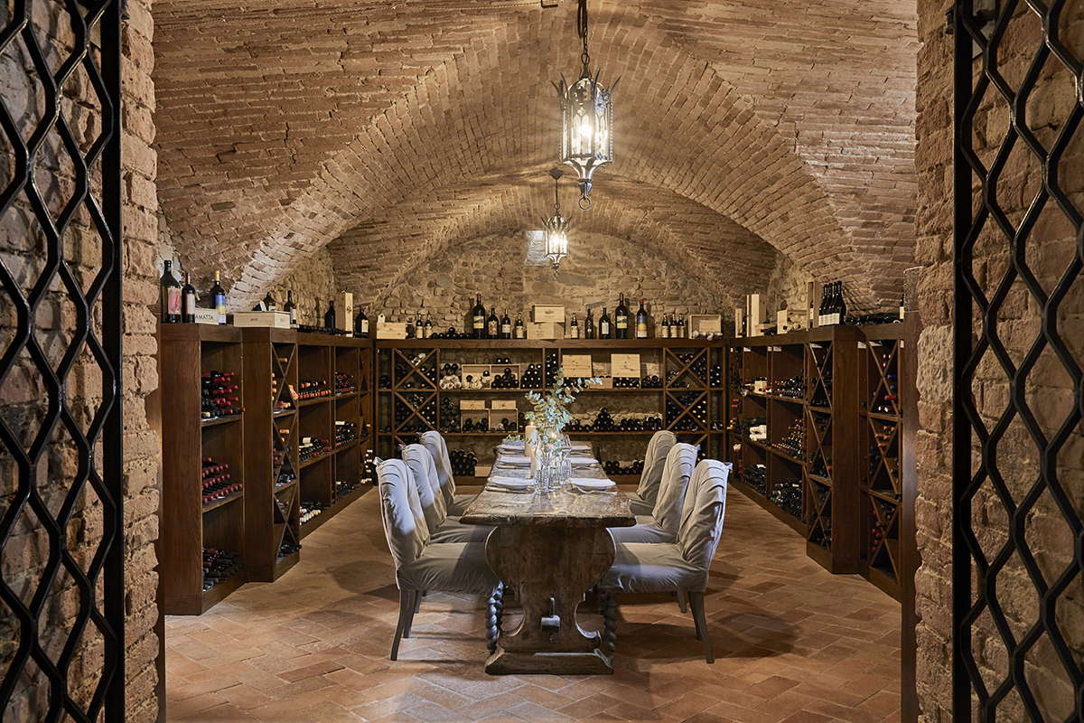 A table and chairs in a wine cellar