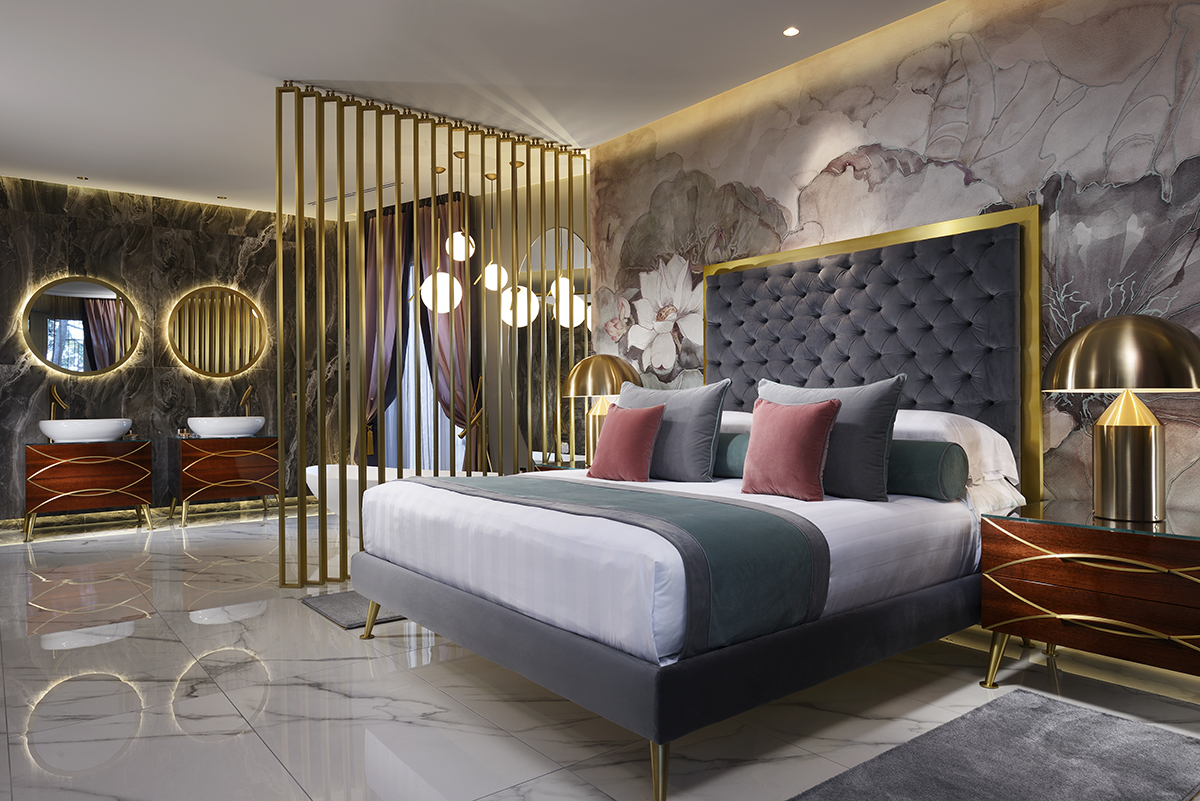 A bedroom with grey and gold colouring and hints of red