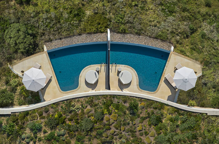 A pool surrounded by grass from a bird's eye view