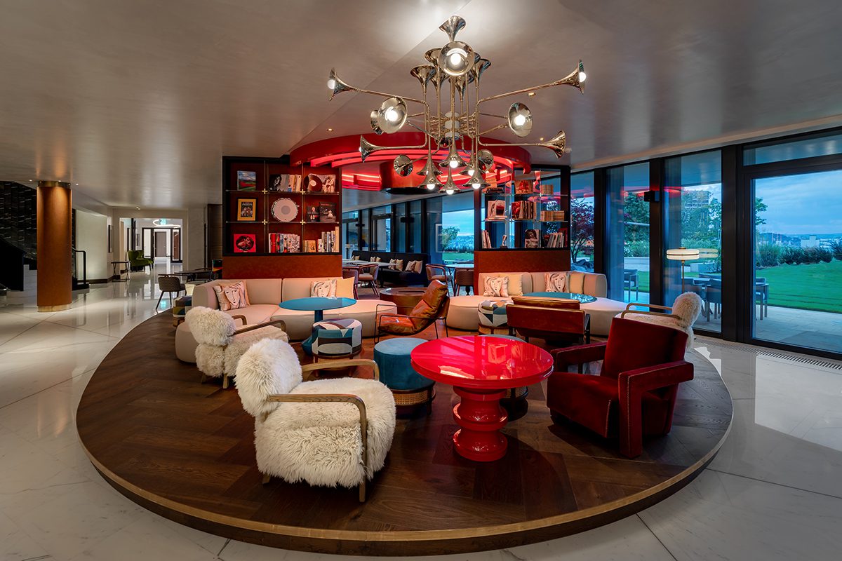 A restaurant with red tables and white chairs