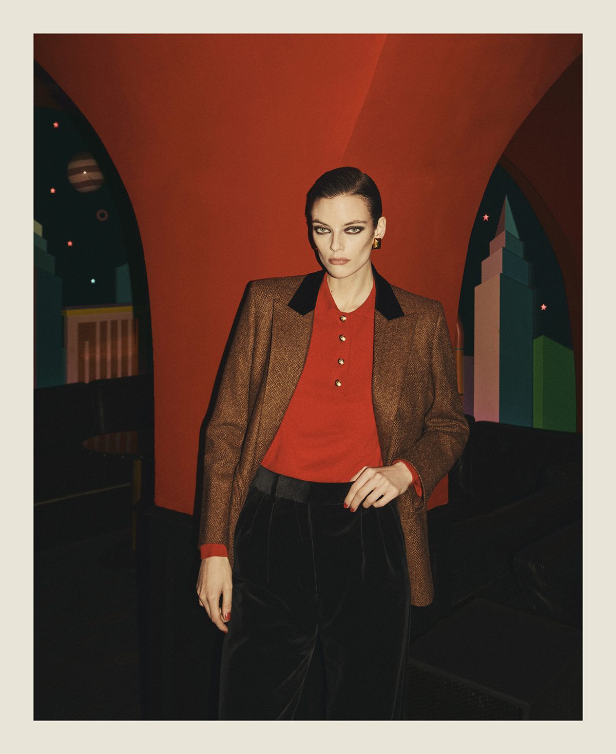 Model wearing a brown blazer paired with a red button up