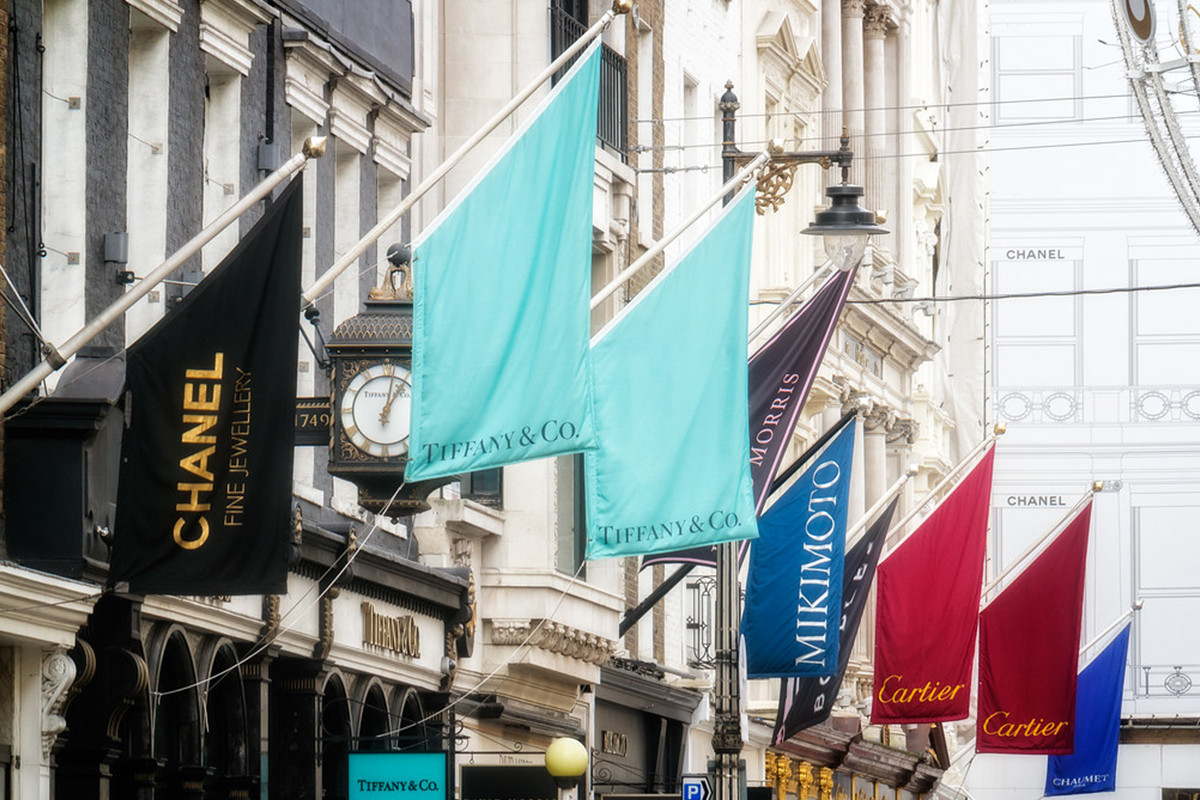 shops with brand flags  over the entrances on bond street