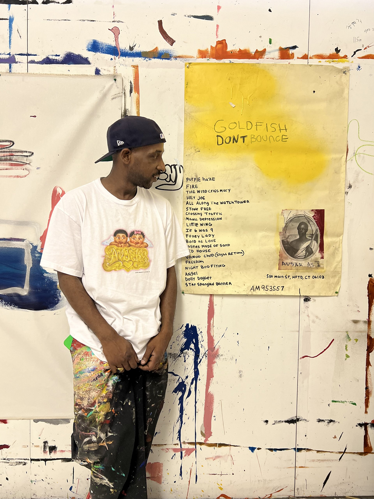 A man standing next to a yellow painting