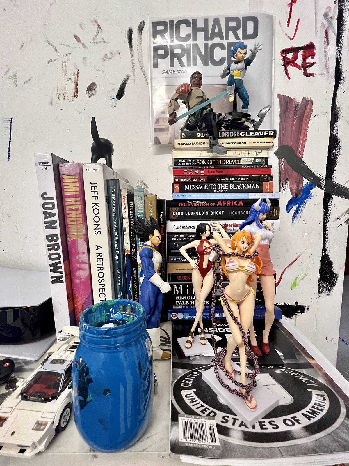 plastic dolls and books on a desk