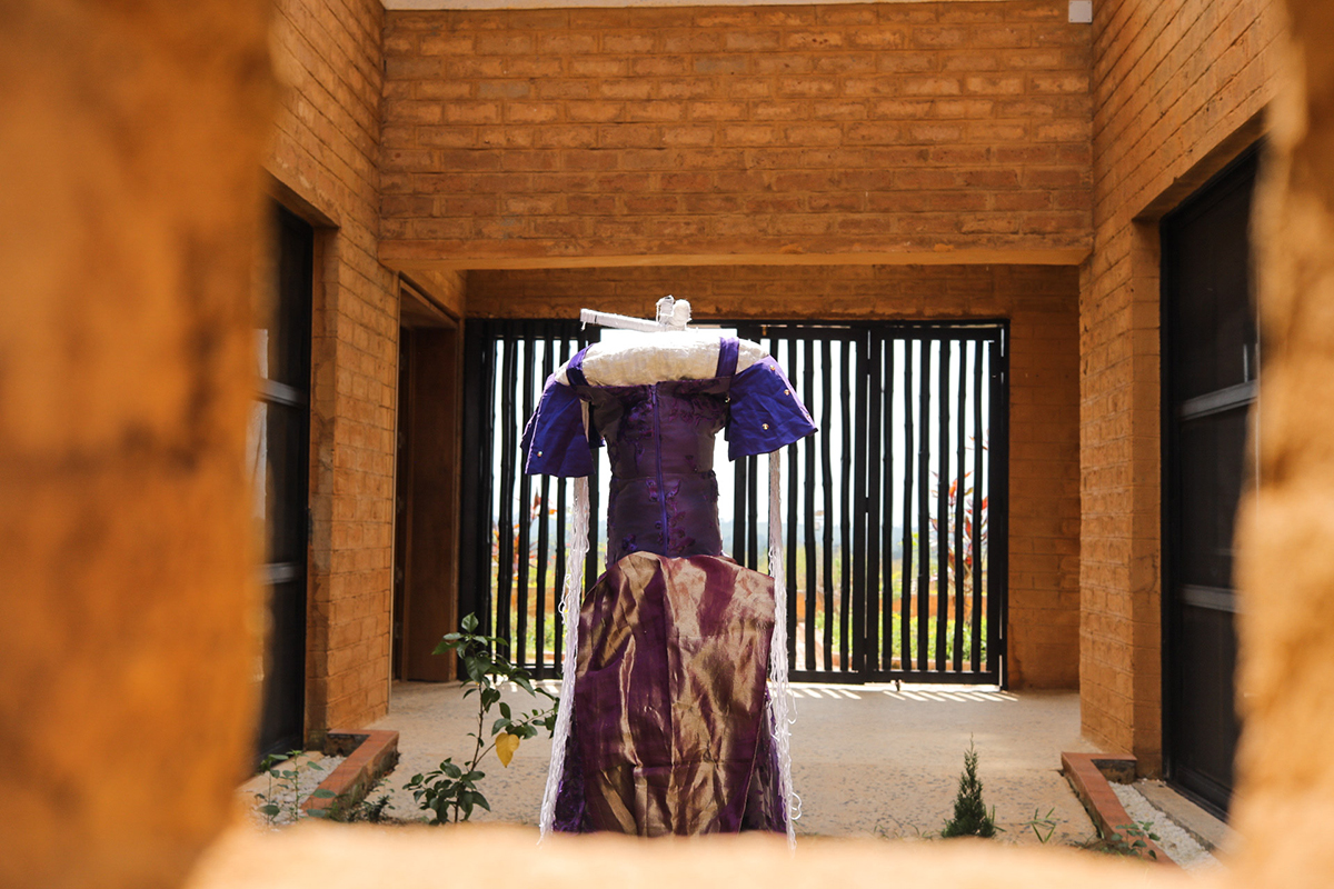 A headless mannequin with a dress on it in a courtyard