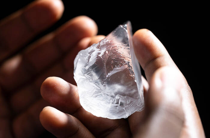 A raw diamond in someone's hand