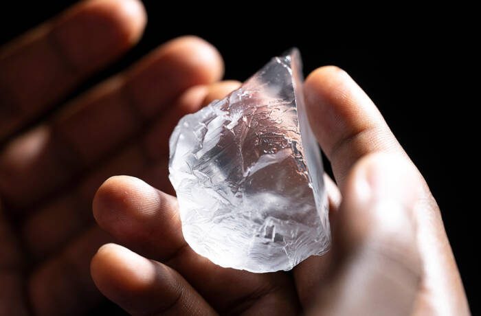 A raw diamond in someone's hand