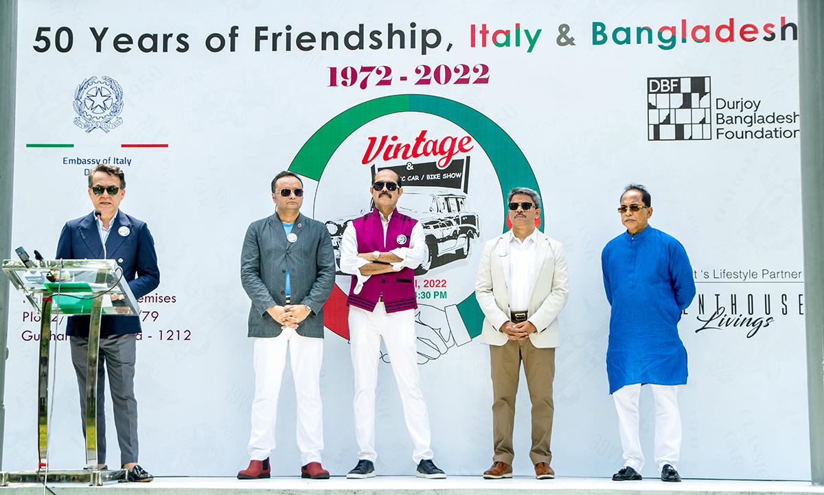 Five men stand by a sign celebrating friendship between Italy and Bangladesh