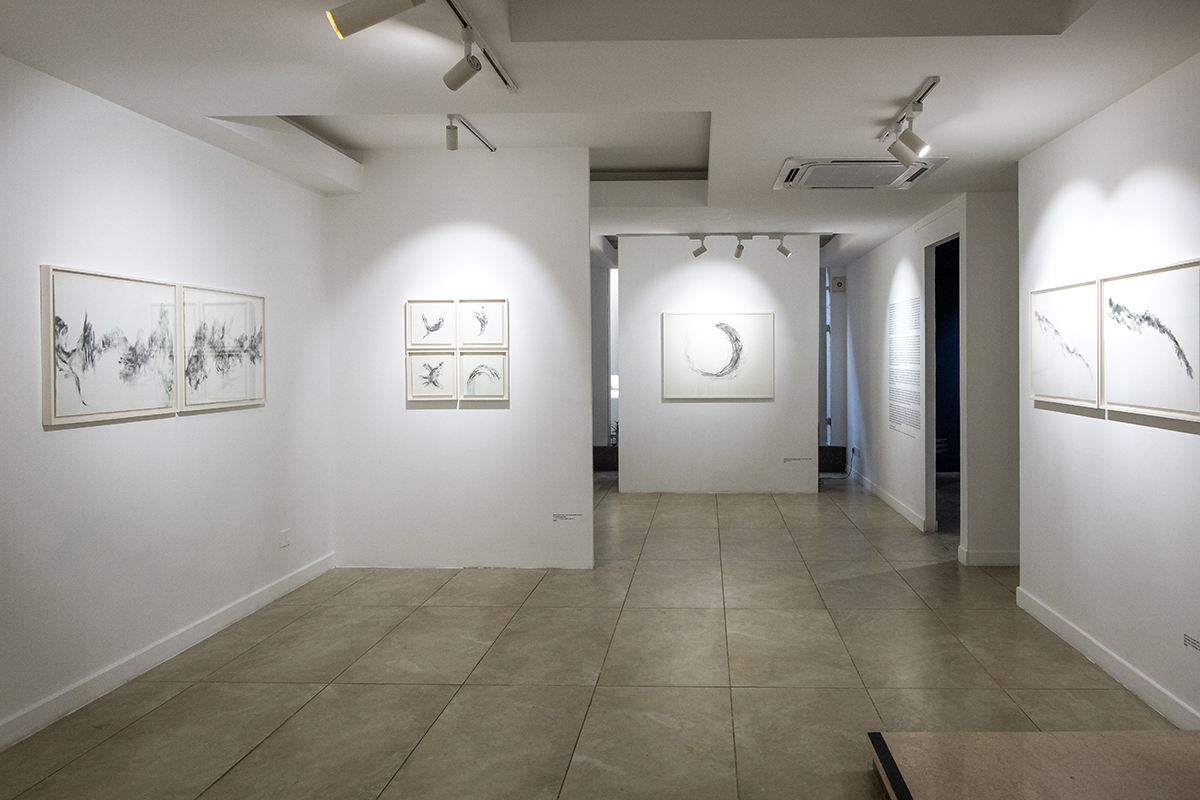 A white room with simple art works on the walls