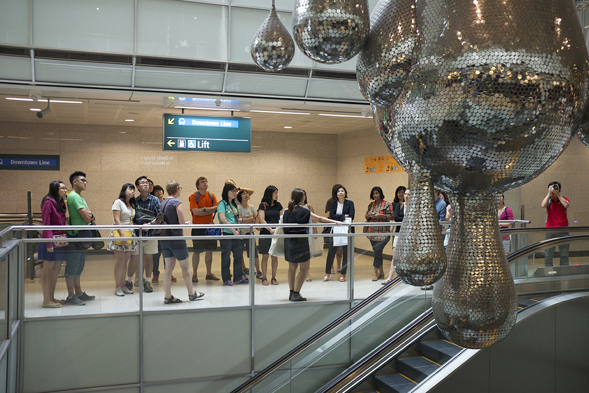 people standing by an escalator on a mezzanin