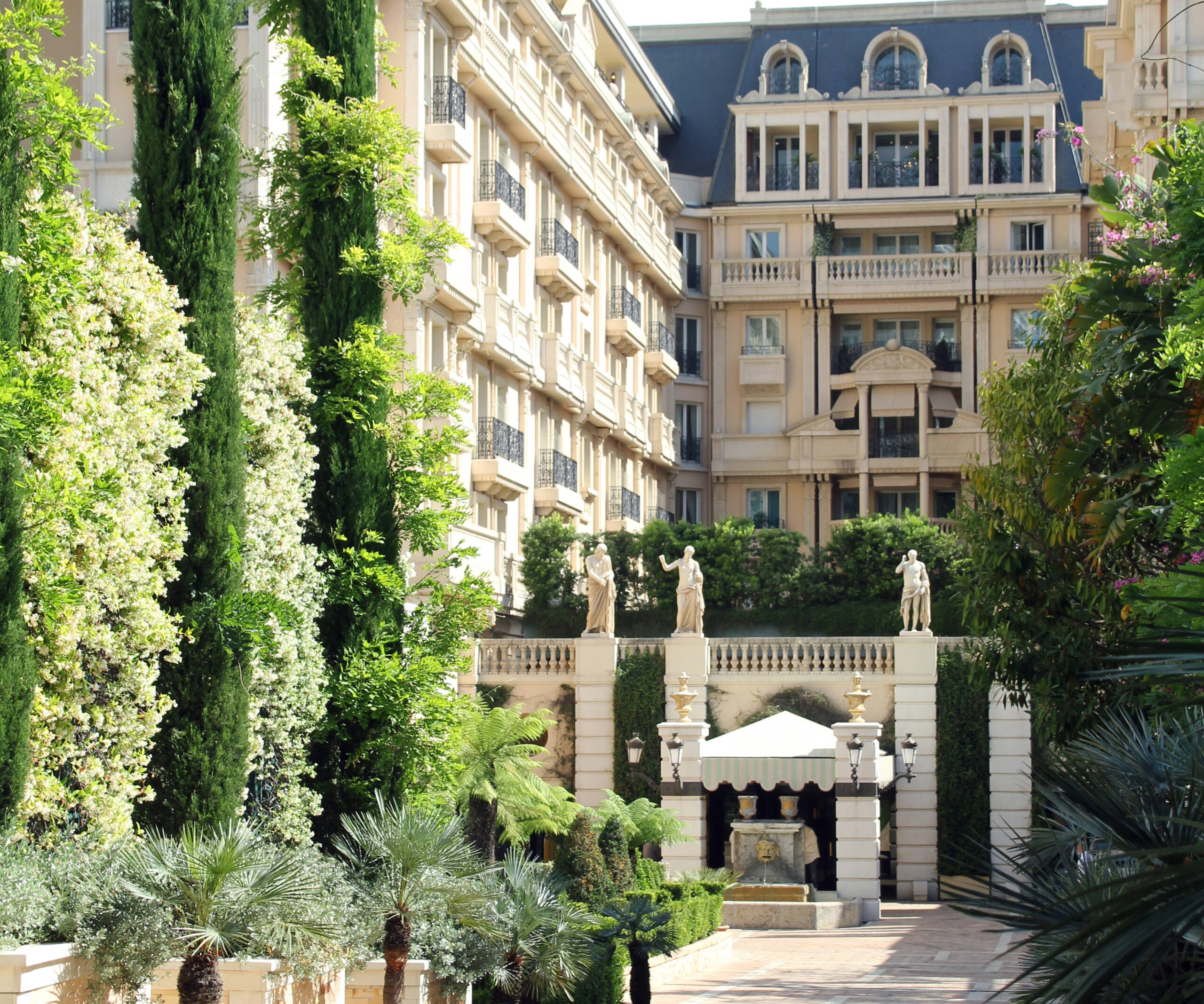 Tall and grand white building surrounded by plants