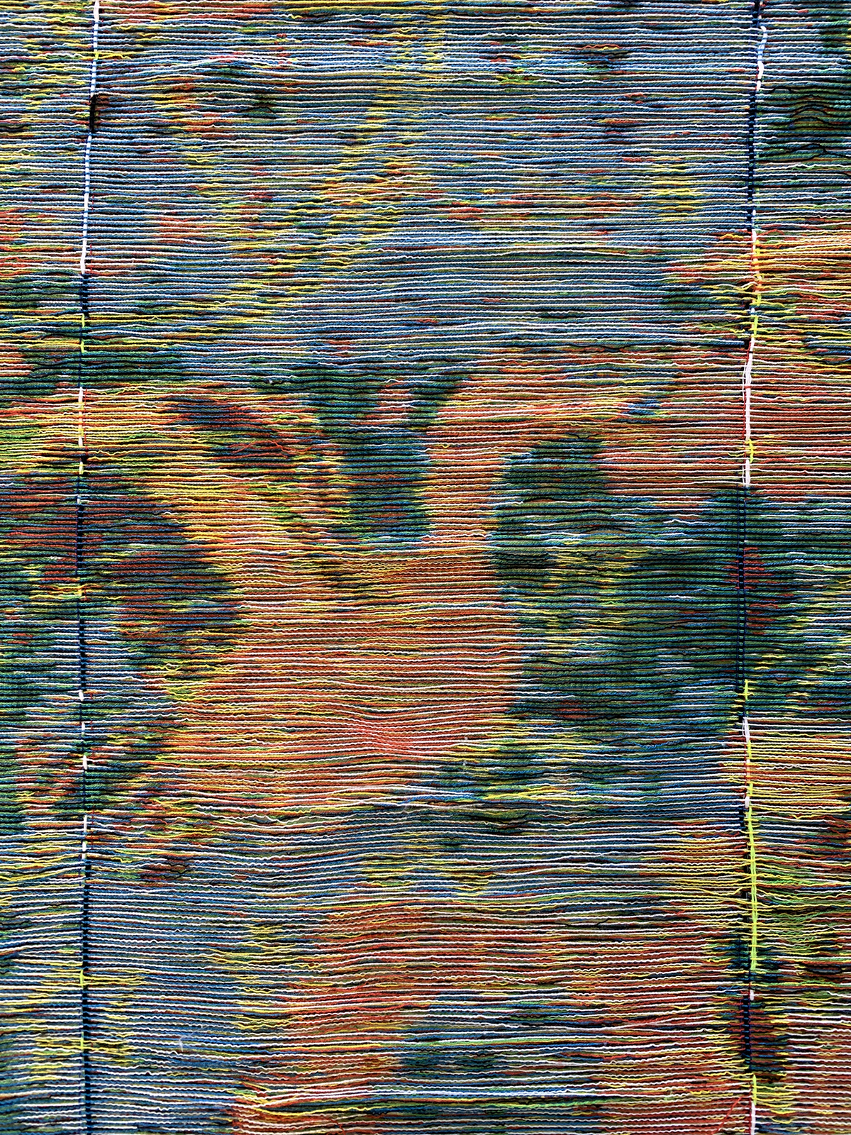 A woven tapestry in pink, blue, yellow and green of a bird flying