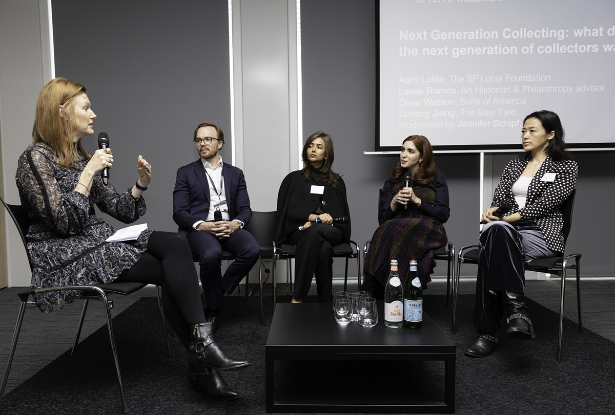 people sitting around a coffee table hosting a panel discussion