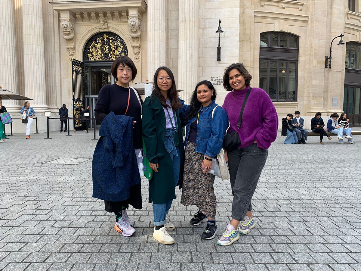 4 women standing together outside a building in Paris