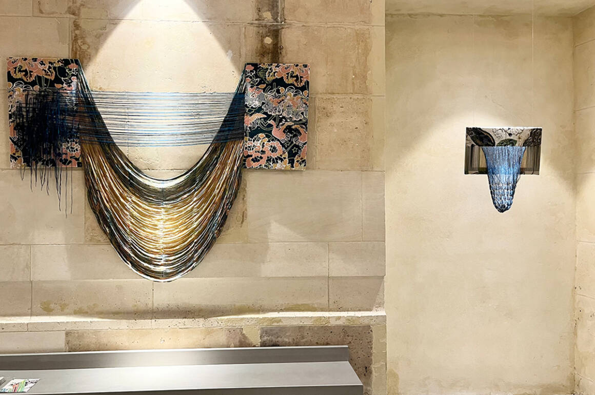 thread hanging on a wall coming of a textile