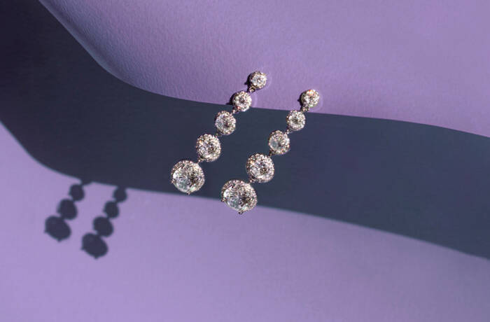 diamond drop earrings on a purple background