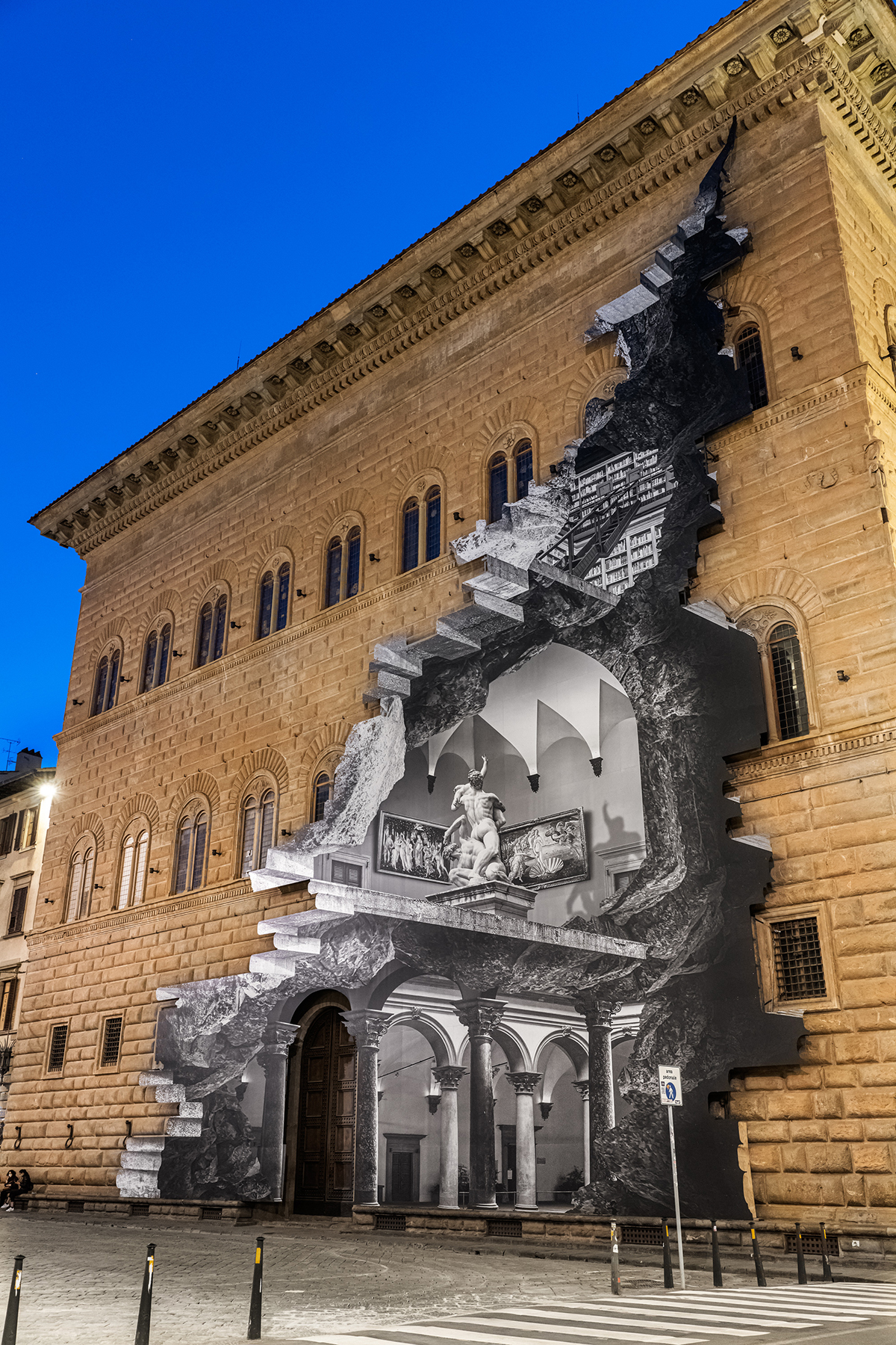 A building exterior with a picture on it showing the inside of the building in grey as if the wall has been bashed through