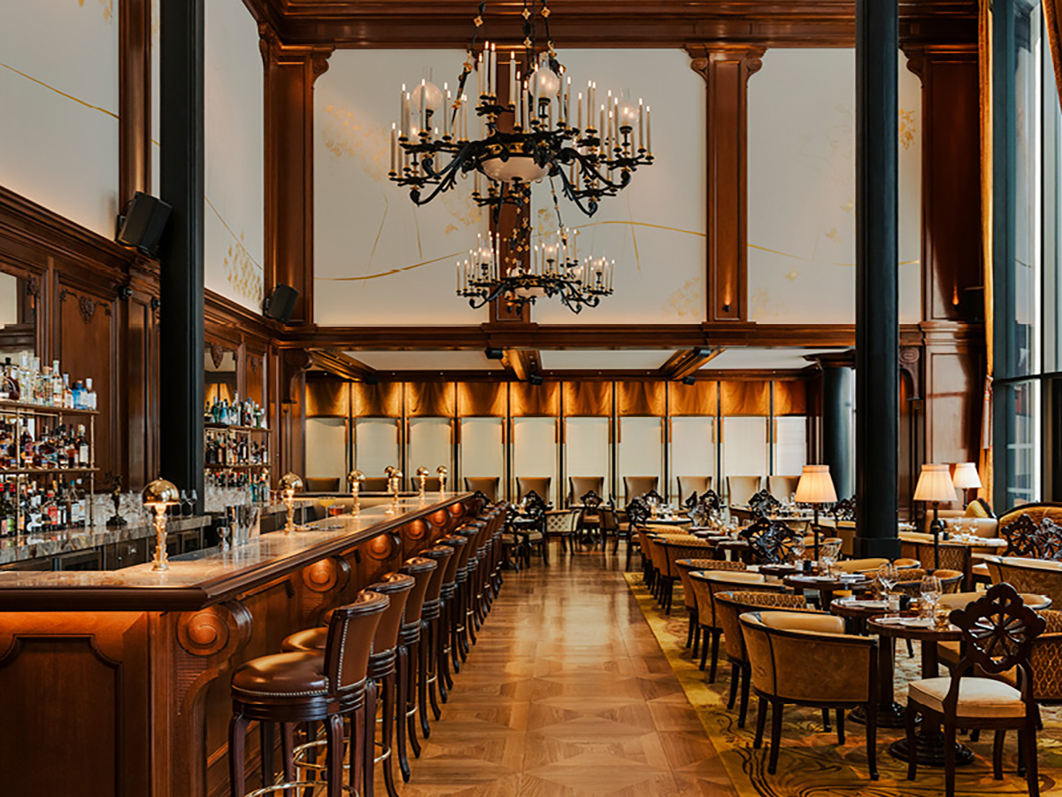 A grand wooden dining room with yellow lights 