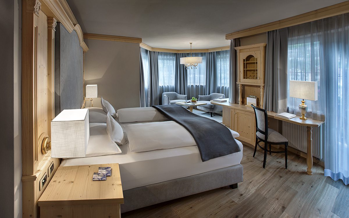 A grey and white bedroom in a wooden chalet style room