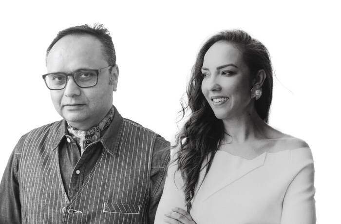 A man and woman standing next to each other in black and white