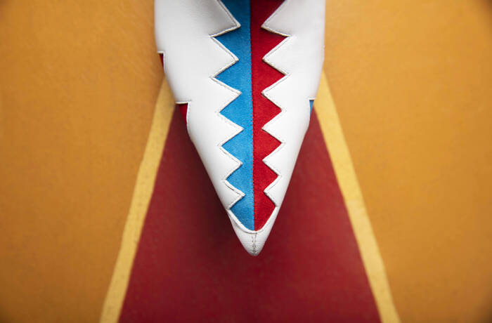 A blue and red zig zag on white shoes