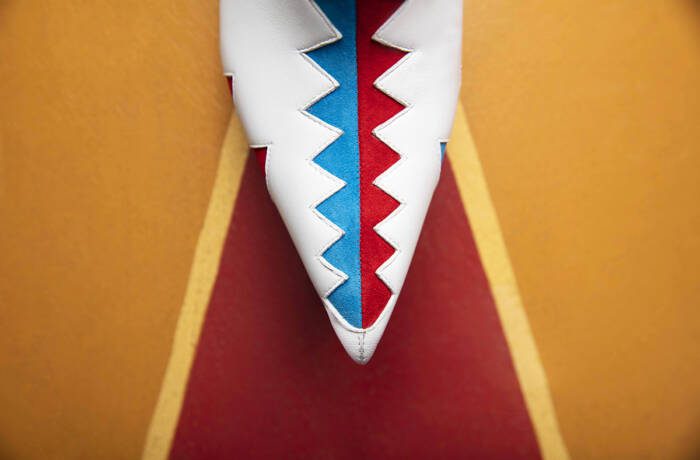 A blue and red zig zag on white shoes