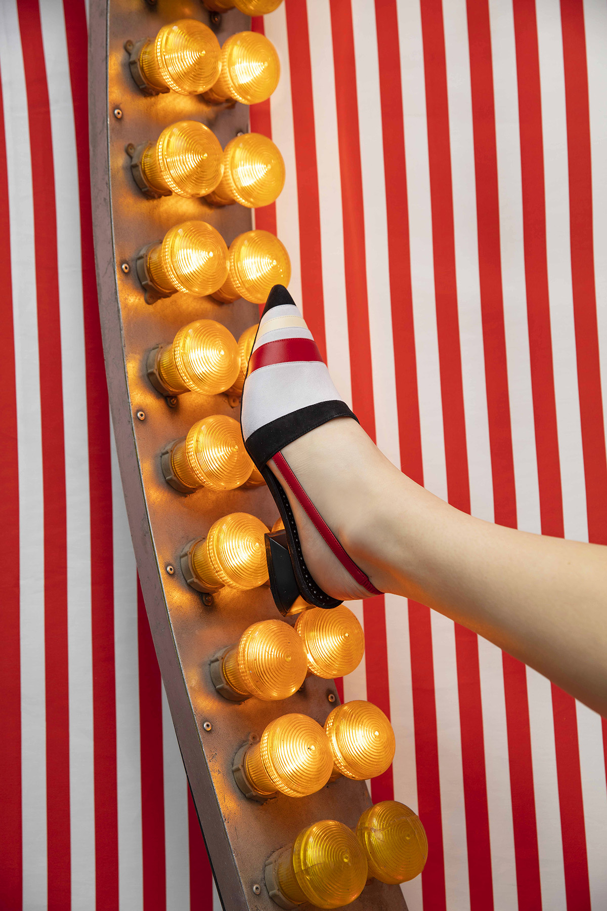 Red white and black kitten heel on a light up sign 
