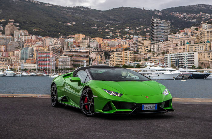 Green sports car, boats in background