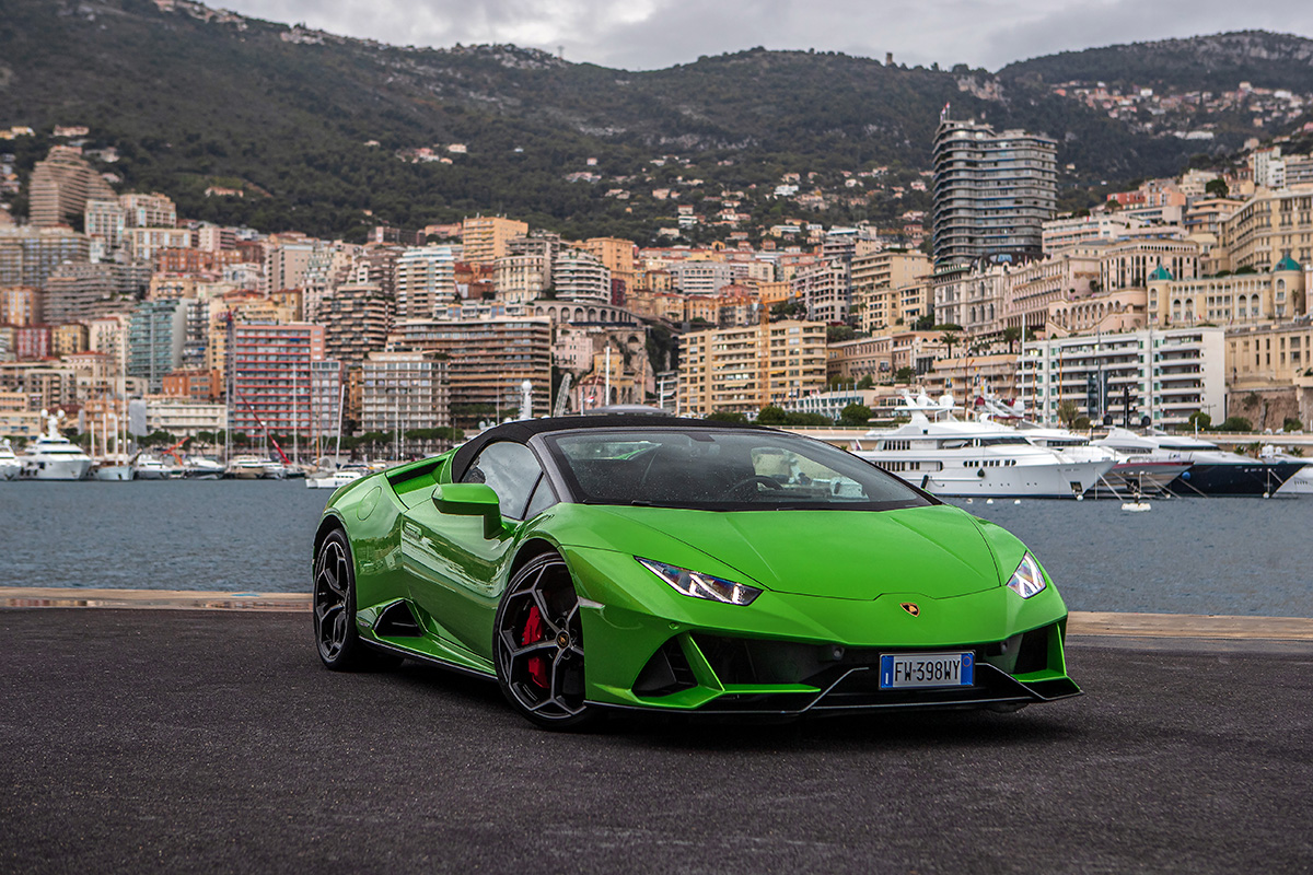 Green sports car, boats in background