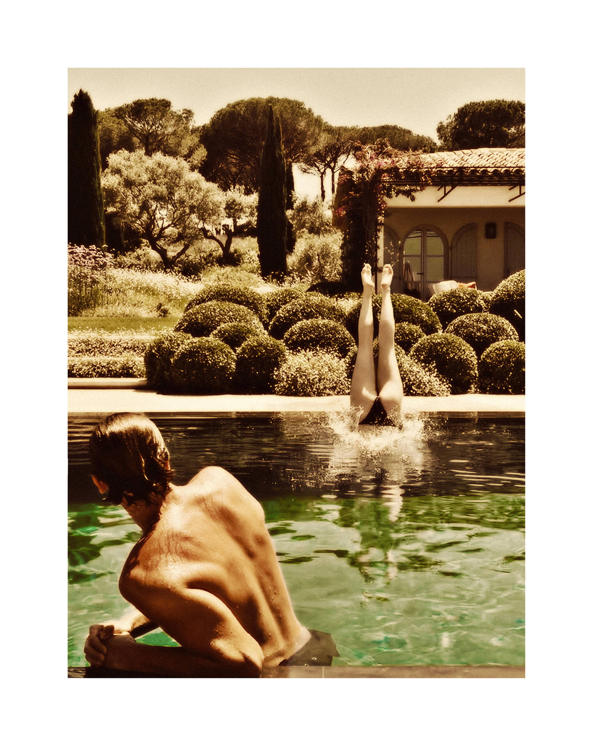 man watching woman dive into pool