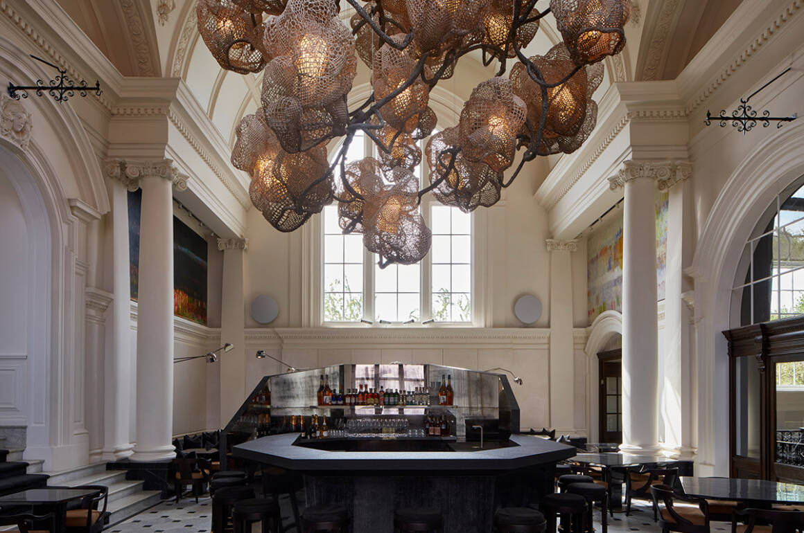 a room with big window and lights and bar