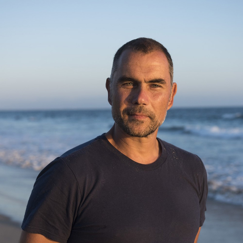 man on beach with ocean in background