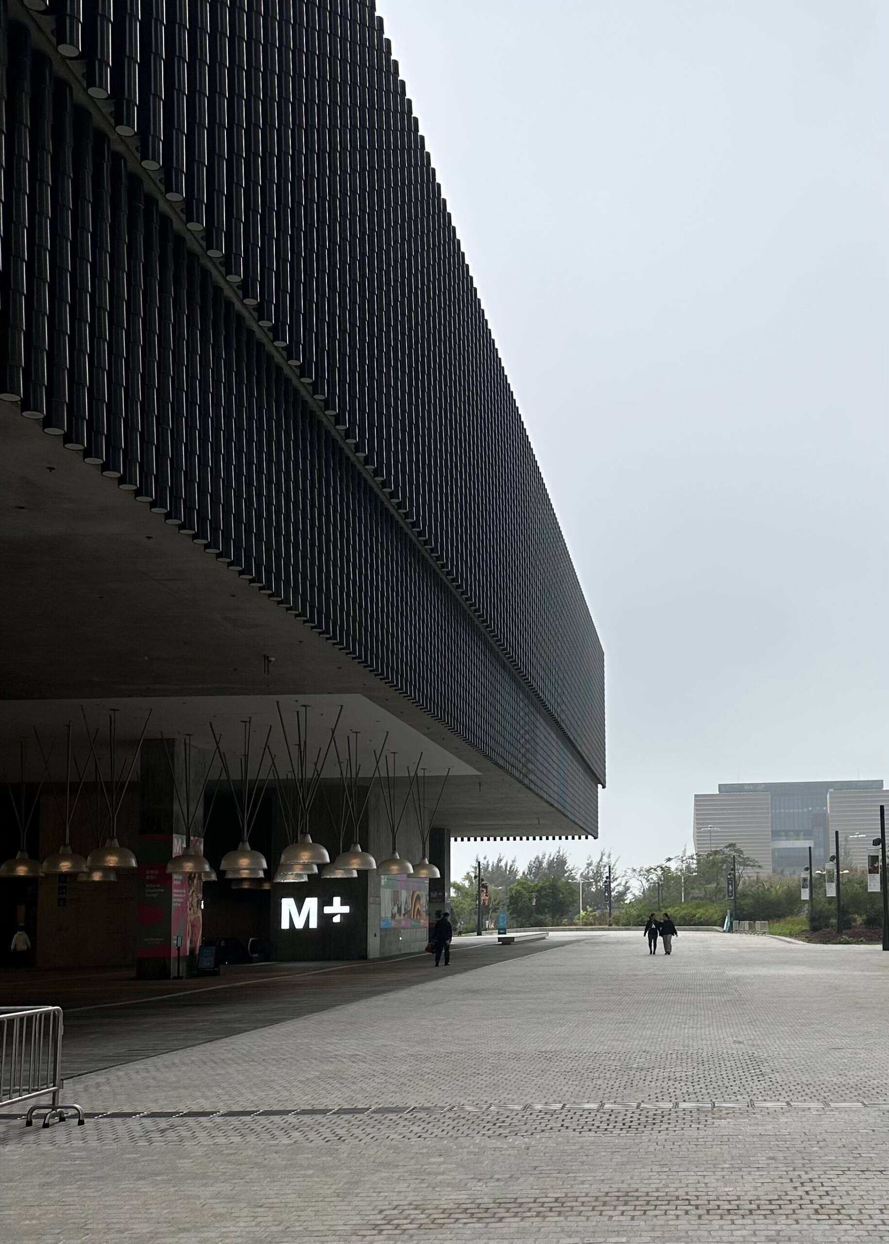 THE OUTSIDE OF A MUSEUM WITH A MODERN LOOK AND A GREYSIH SKY