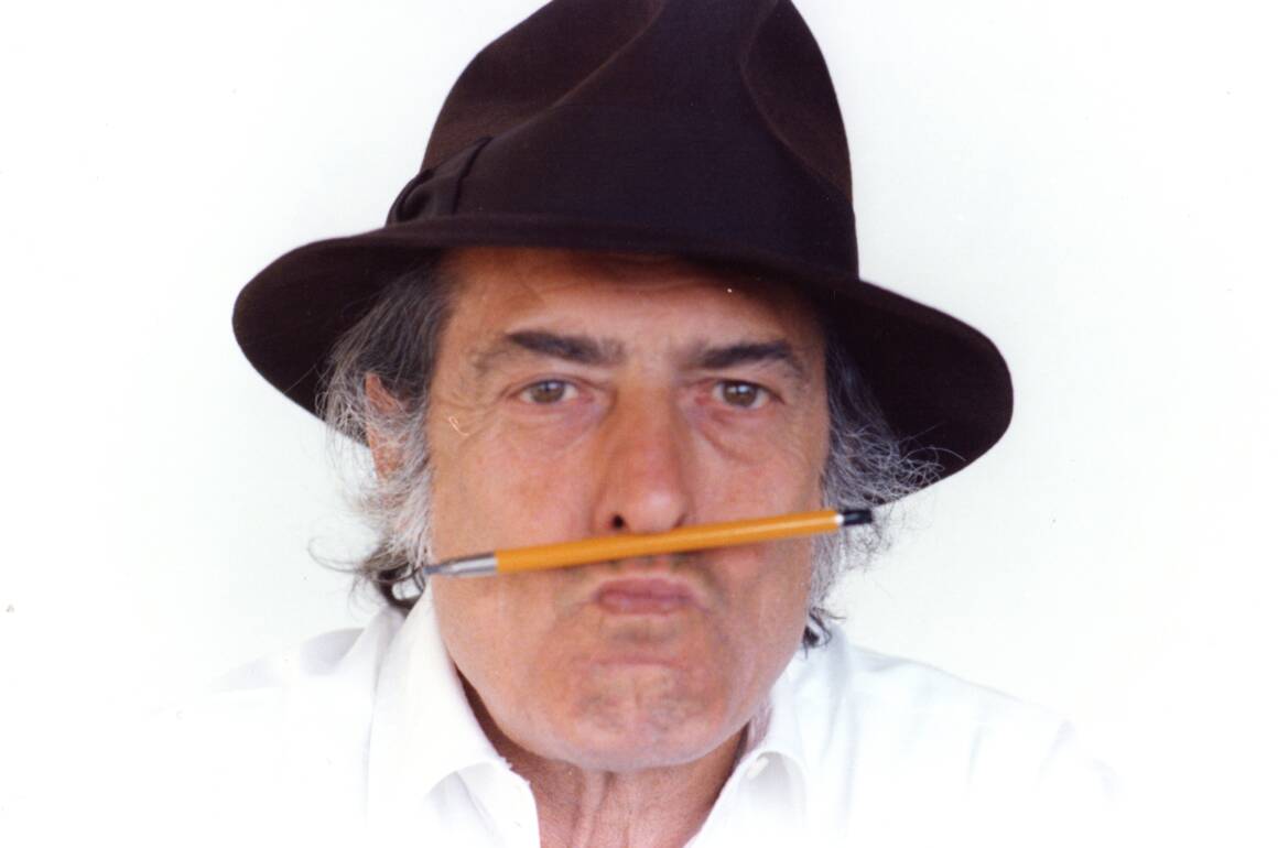 a man with a pencil between his lips and a hat on his head